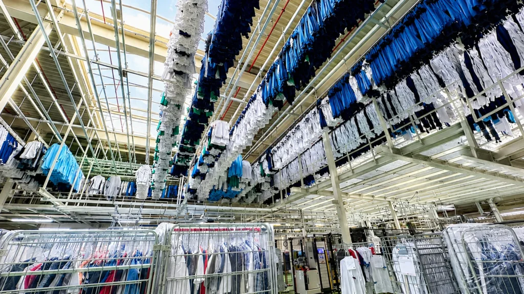 Large-scale textile service operation with linens moving through a commercial laundry
